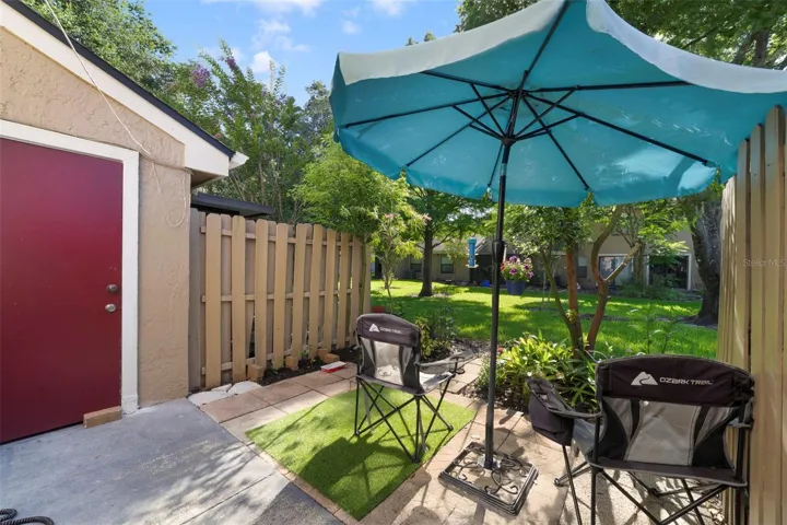 Step outside to the rear patio, complete with PRIVACY FENCING on both sides.