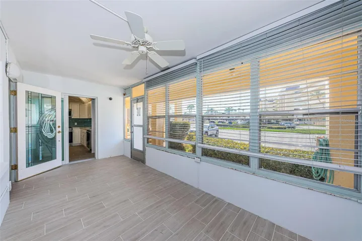 Florida room with front door to living room and sliders to the kitchen