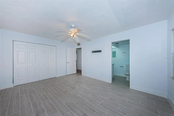 Primary bedroom showing closet and bathroom
