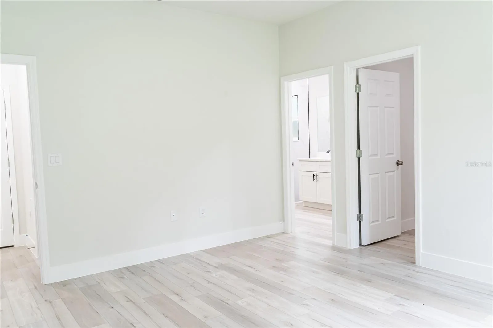 Primary bedroom with walk-in closet and ensuite bath