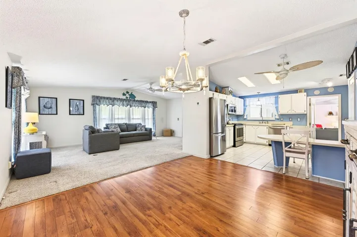 Seamless flow between living room, dining area and kitchen.