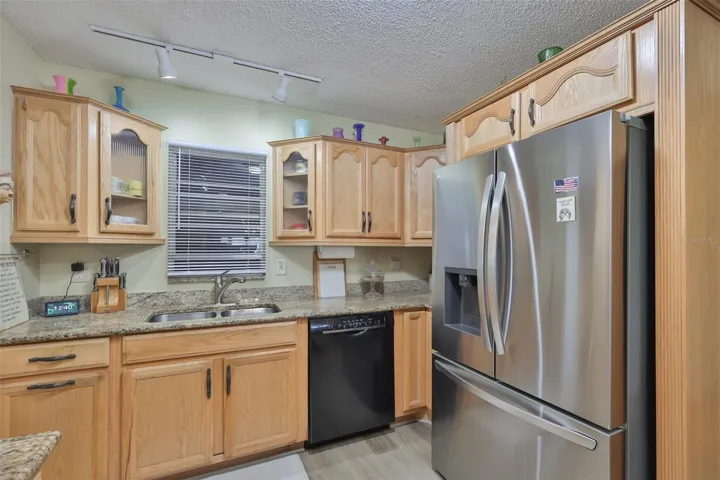 Granite Countertops, Ample Wood Cabinets, SS Fridge, Range &amp; Microwave