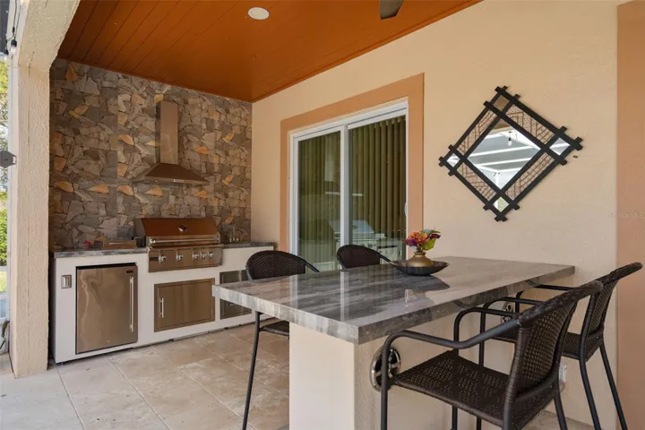 Outdoor Kitchen and outdoor seating with built in speakers