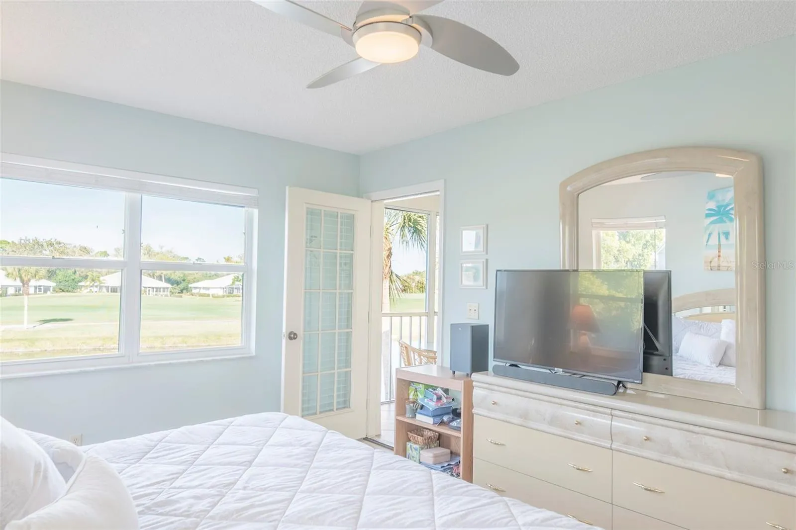 Primary suite opens up to the exterior balcony.