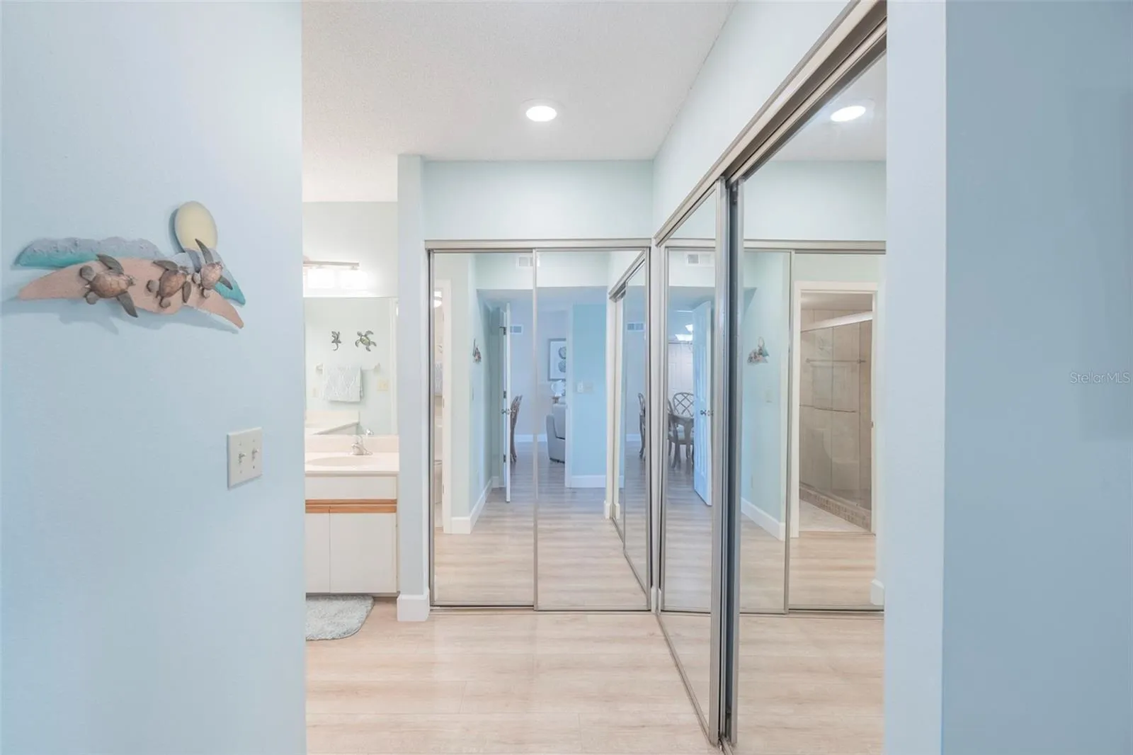 Entering into the primary ensuite bathroom, there is plenty of closet space.