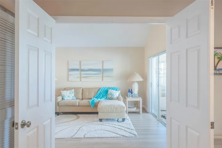 Enter the living room from the third bedroom.