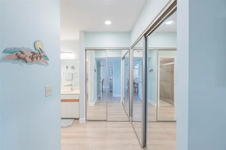 Entering into the primary ensuite bathroom, there is plenty of closet space.