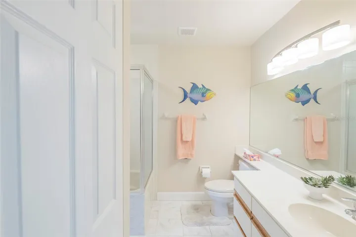 Large second bathroom leads to third bedroom.
