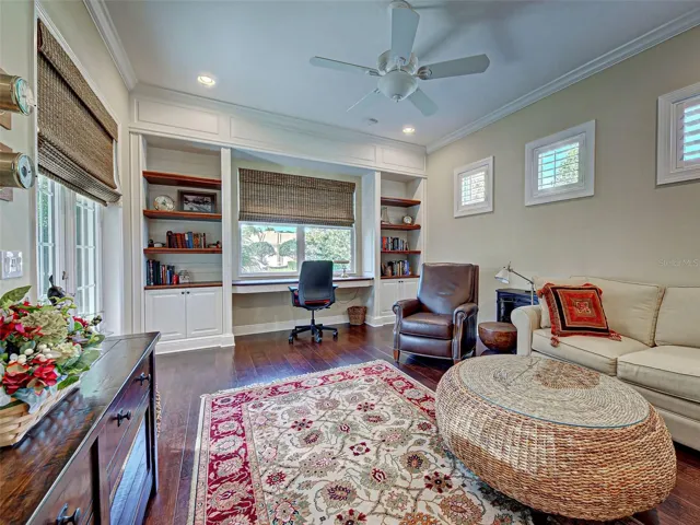 Den is so large and bright with its many windows.  Custom designed built in shelves, crown molding and detailed woodwork make this room so special.