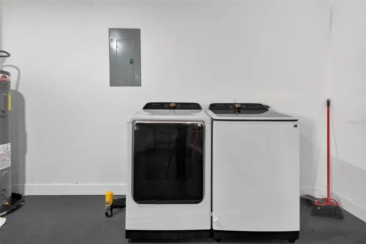 Garage with washer dryer hook up and exterior door.