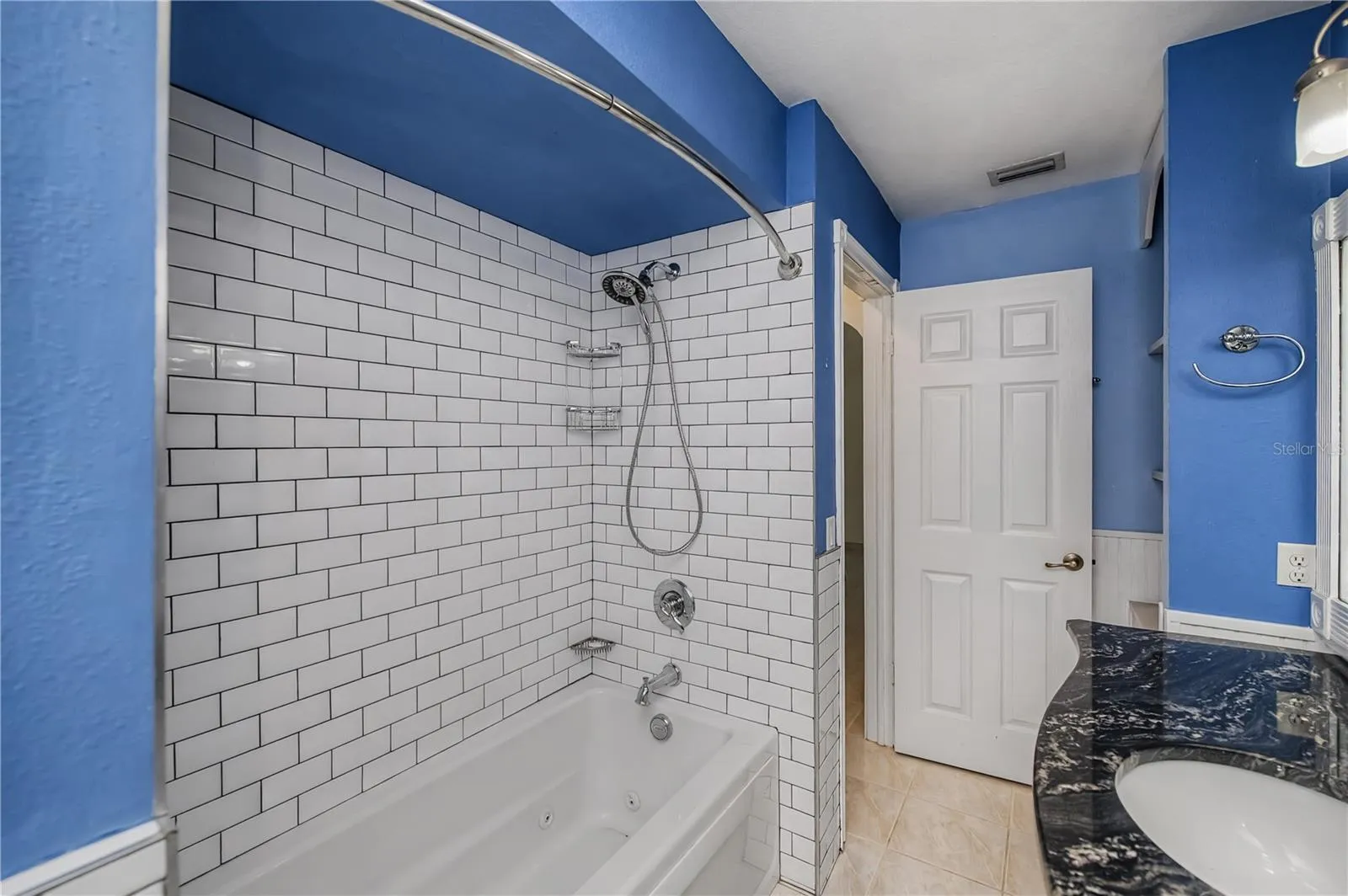 Guest Bathroom with Subway Tiled Tub/Shower Combo.
