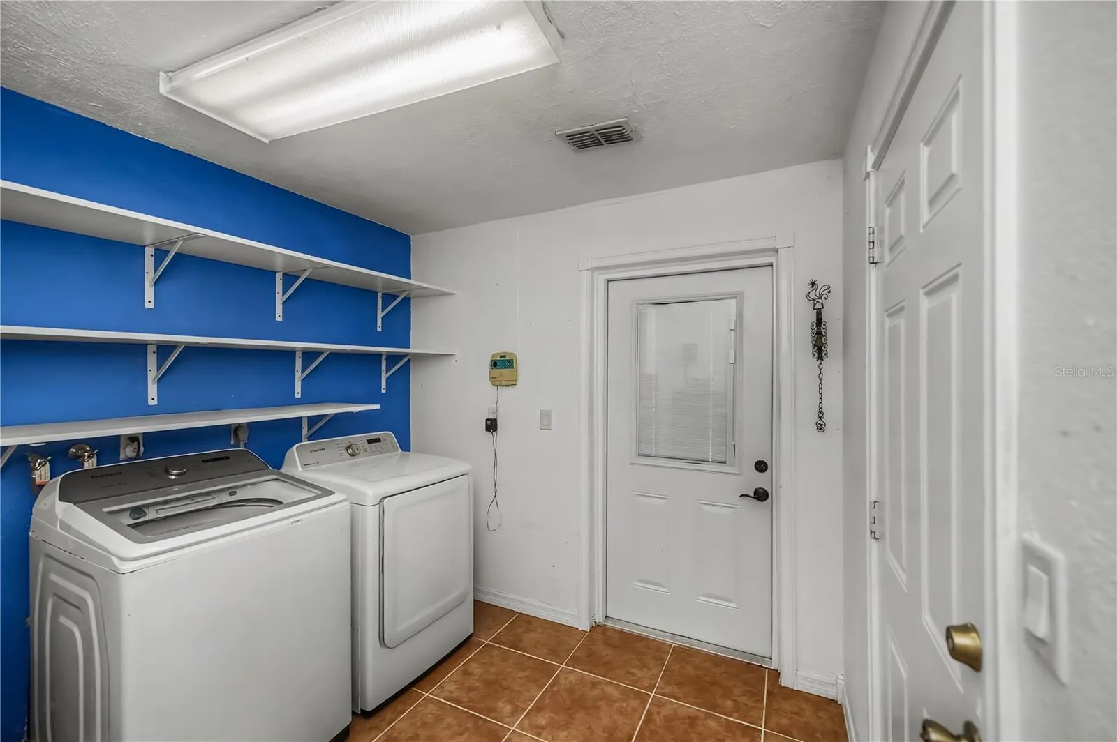 Laundry Room with Utility Sink and Extra Storage Space.