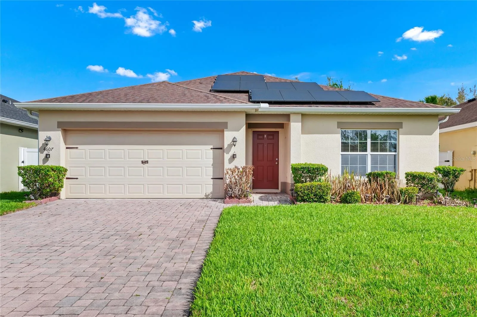 Front of home with pavers on Driveway