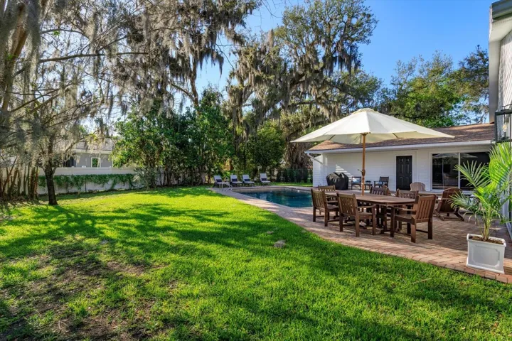 Spacious back yard with shade and oak trees
