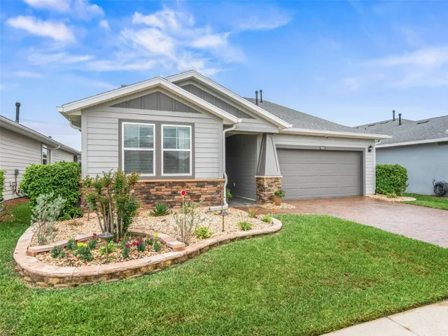 Beautifully landscaped with flowering bushes and plants