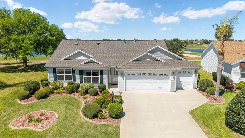 Elevated FRONT EXTERIOR View @ 1397 Eagle Ridge Drive, VILLAGE of LIBERTY PARK. WHISPERING PINE Designer with 3 BR/2 BA/2.5 Car Garage & a picturesque 180° GOLF COURSE FRONTAGE & WATER VIEWS on Cane Garden Championship Course, Allamanda - Hole #5