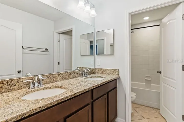 full bathroom upstairs with 2 sinks