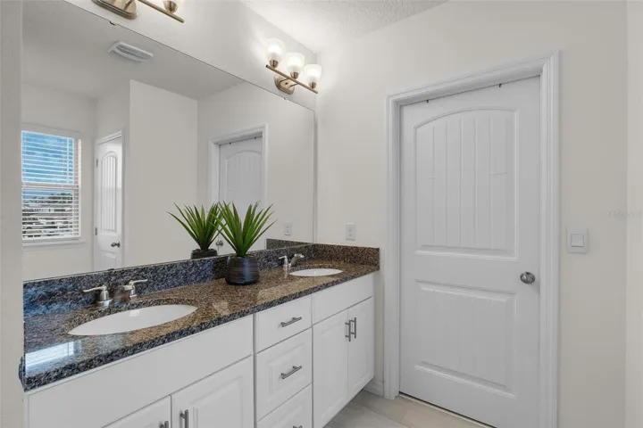 Primary Bath with Double Sinks, Granite Counters & Extra Stack of Drawers PLUS Large Walk-In Closet .