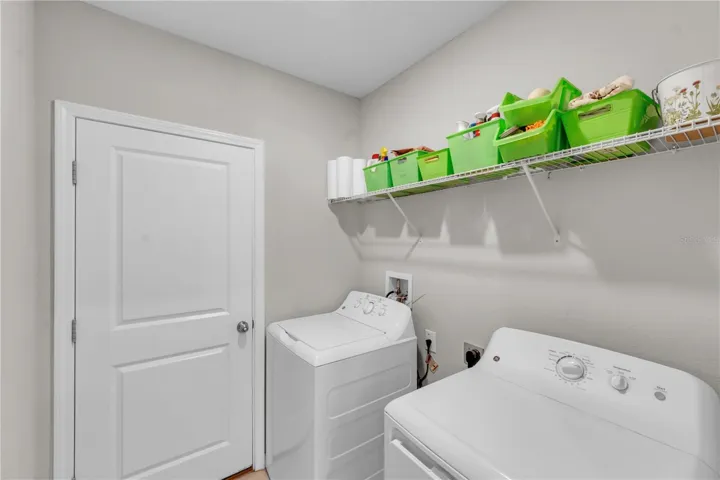 Laundry room leading to 2-car garage