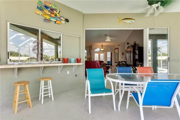 Lanai with bar and slider windows from kitchen