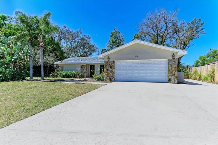 Front of home with wide driveway