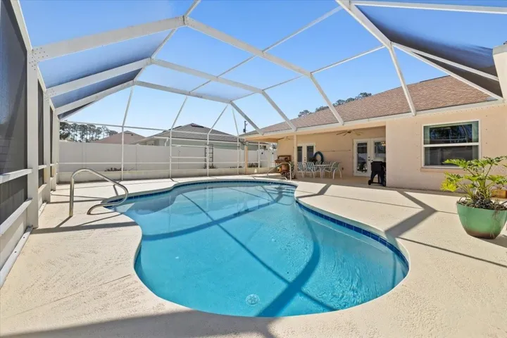 Private screened-in pool and lanai offering a serene outdoor retreat ideal for year-round enjoyment.