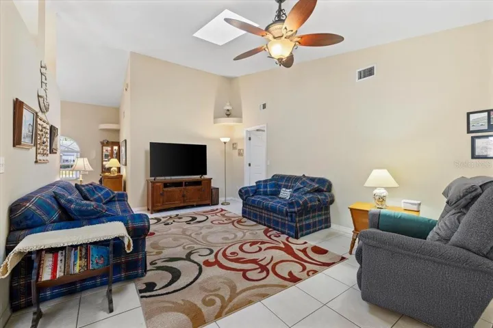 Spacious family room, offering a comfortable setting for relaxing or entertaining. A warm and inviting space perfect for everyday living