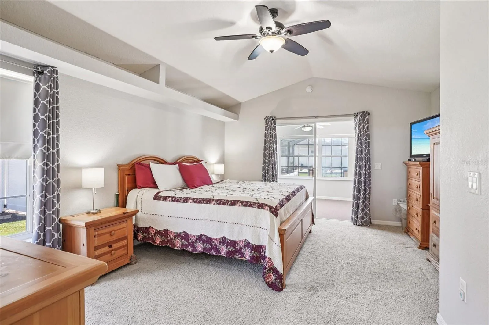 Primary Bedroom with Sliding glass doors to the Florida Room and pool.