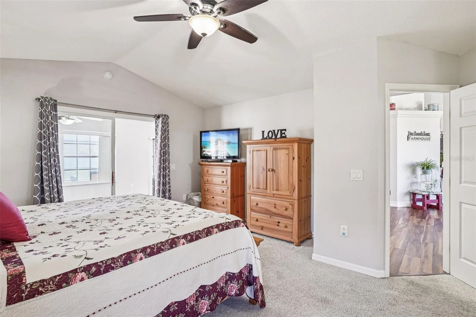 Primary Bedroom with Sliding glass doors to the Florida Room and pool.