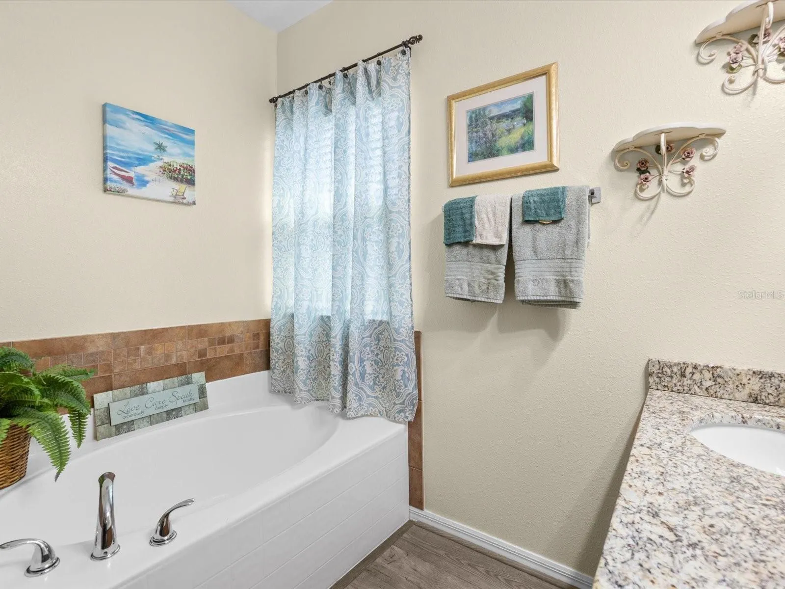 Primary bathroom with tub and double sink.