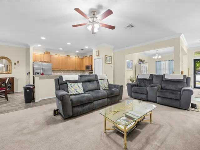 Family room with view into the kitchen and dining room
