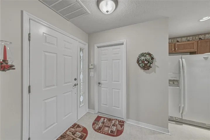 The foyer area has the door to the attached 2 car garage.