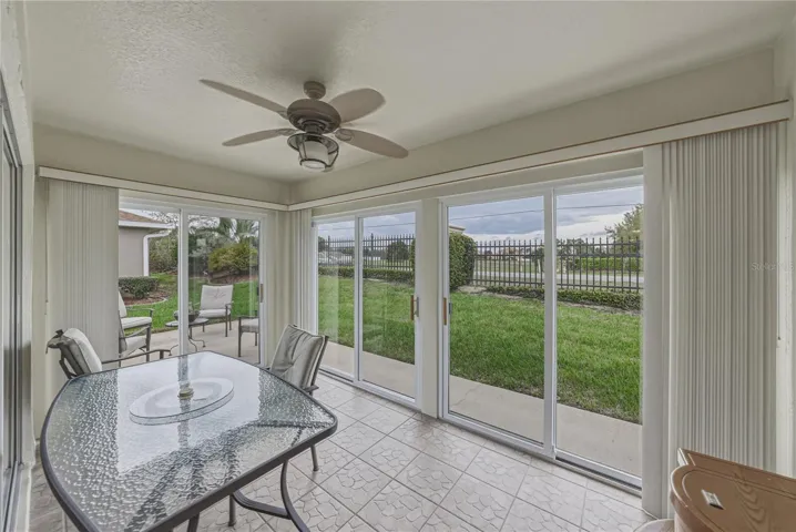 Outside the enclosed lanai is an outdoor open patio that wraps around the rear of the home.