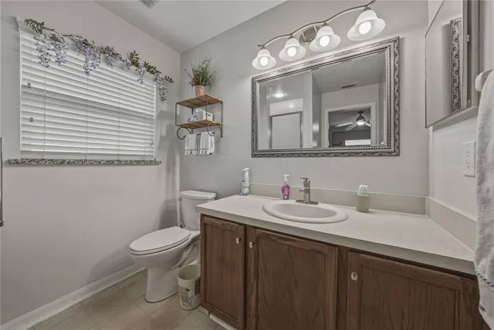 The primary bath has an elevated vanity, elongated comfort height stool, and upgraded lighting.