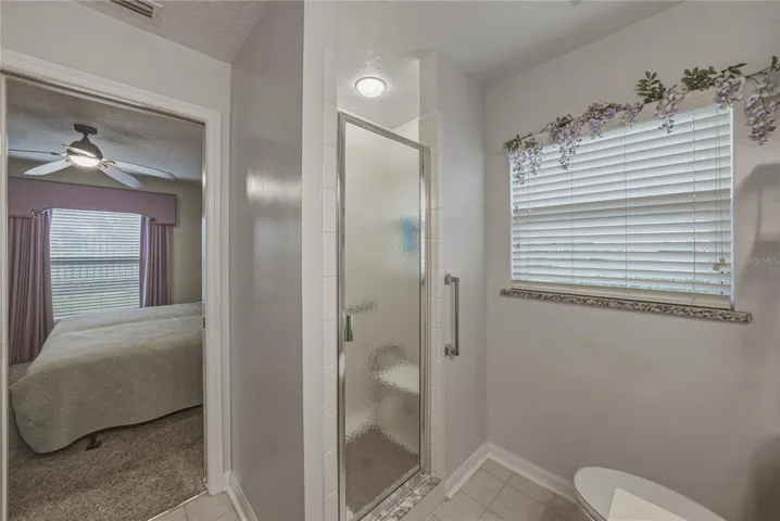 The primary bath has a stall shower with shower door.