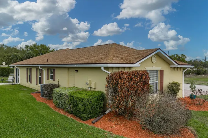 The attached garage has a pull-down attic ladder and a service door that is visible in this view.
