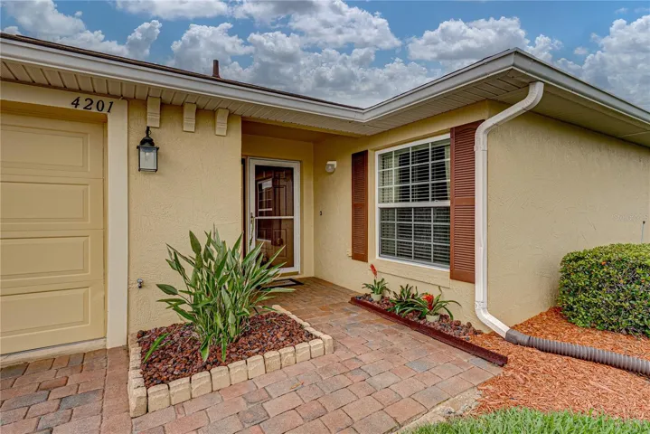 The covered front entry has a full glass storm door.