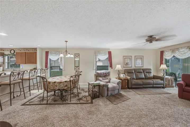 The combination dining and living room gets great natural light from the 2 windows and fully glass enclosed lanai.