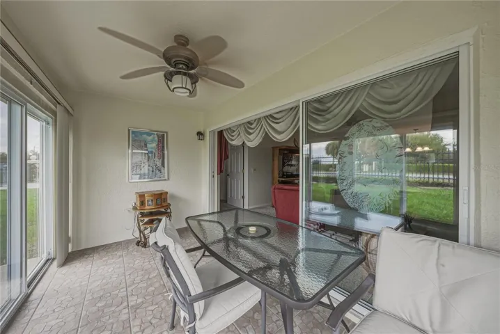 The fully enclosed lanai has ceiling fan with light and ceramic tile flooring.