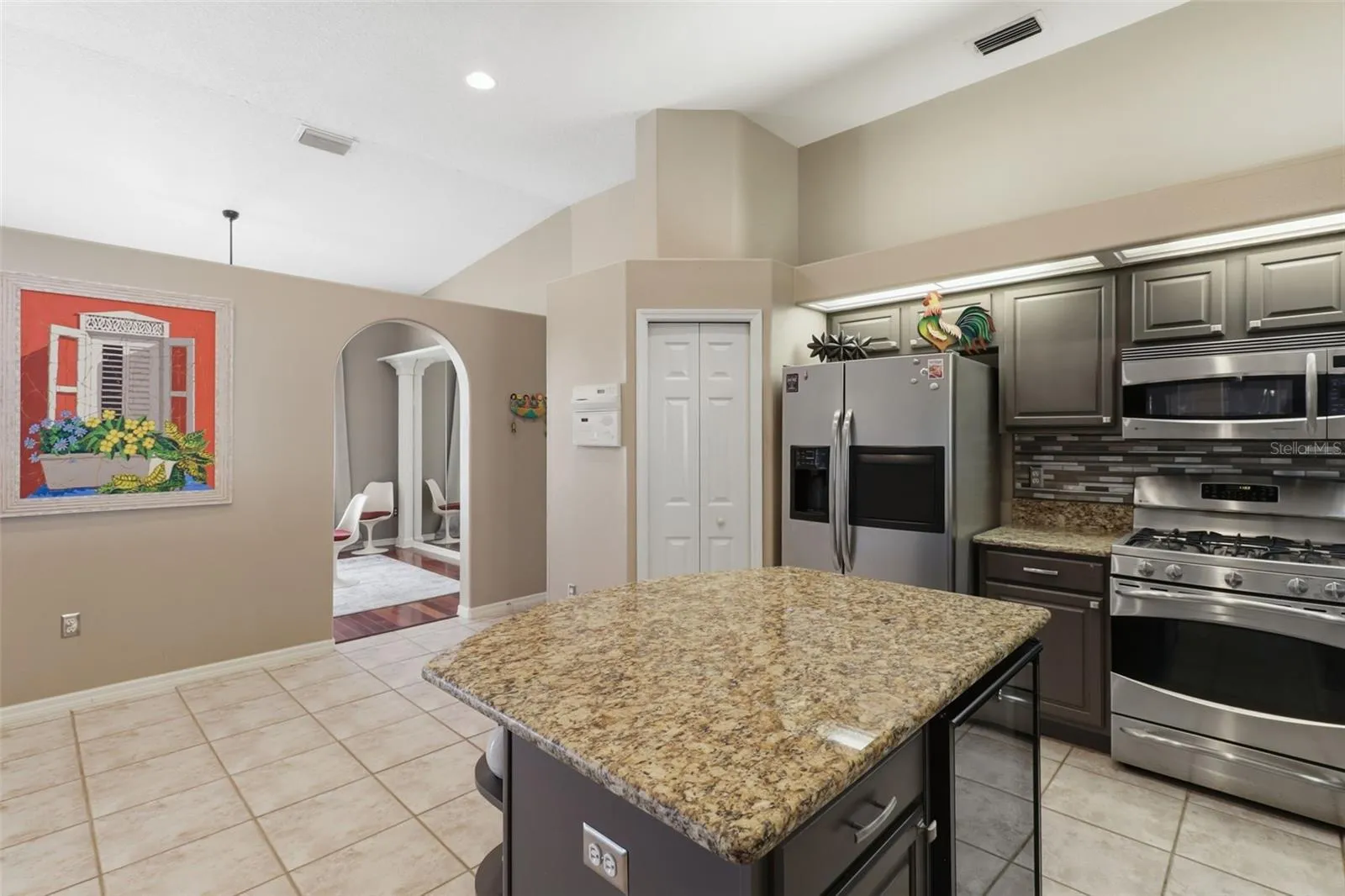 Functional kitchen layout with convenient access to the pantry, formal dining room, and garage entry