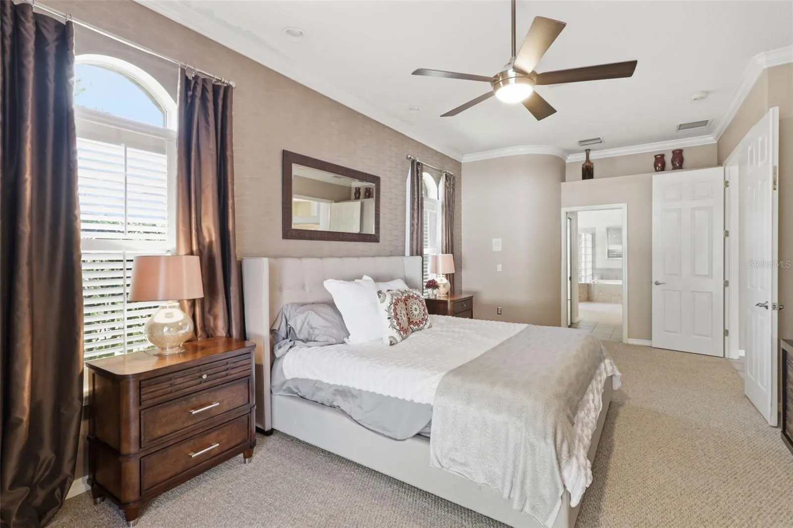 Alternate view of the spacious primary suite showcasing natural light and direct access to the pool