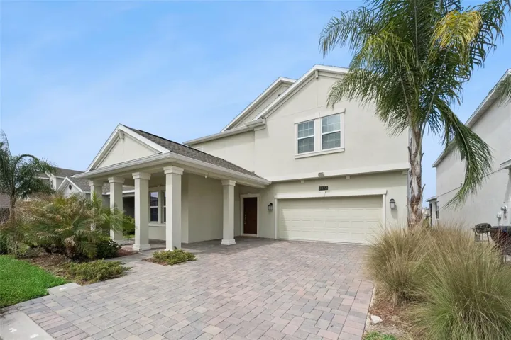 Great curb appeal and a backyard built for gathering—pavers, space to grill, and water nearby.