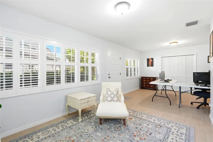 Florida room with lots of soft filtered light, currently being used as office.