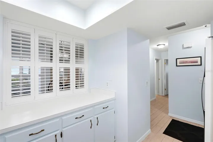 Pass through in kitchen with hallway leading to bedrooms in the background