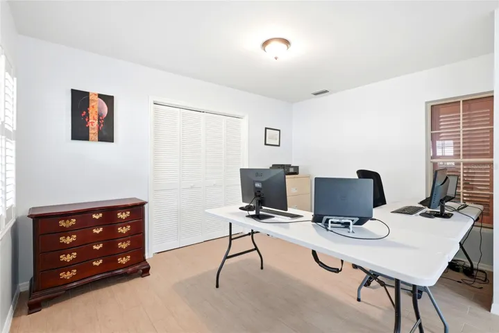 Office in Florida room has an oversized storage closet