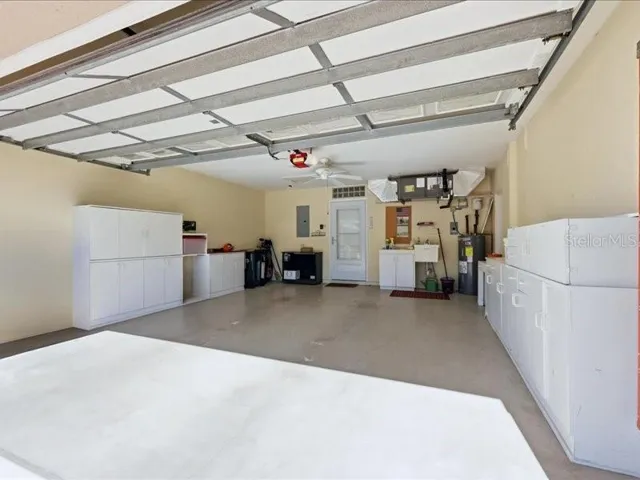 Large 2 car garage with Utility sink, work area and ?? storage cabinets and  pull down stairs