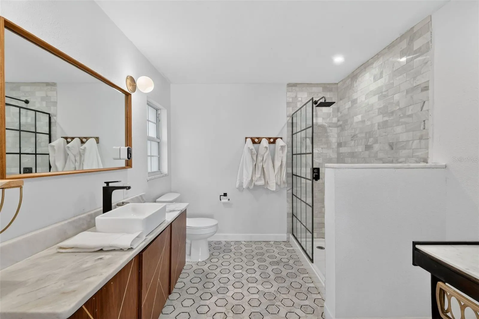 Primary bathroom with Carrara Marble flooring and countertops