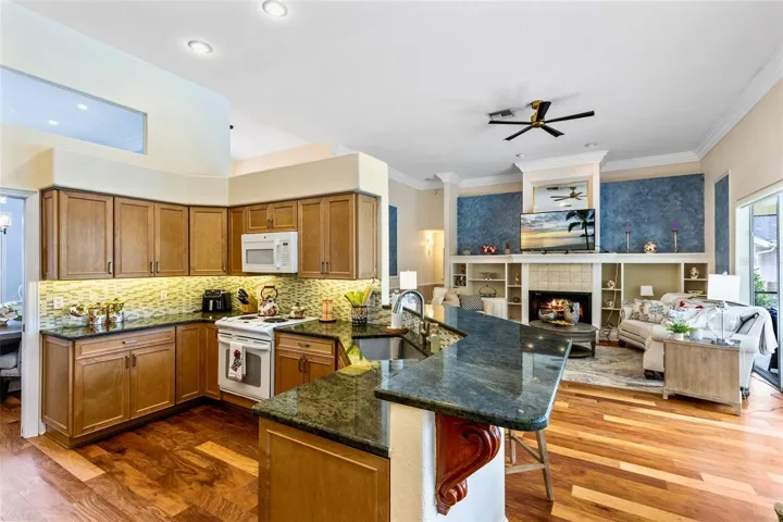 THE KITCHEN HAS CUSTOM GRANITE COUNTERS AND NEWER REFRIGERATOR AND DISHWASHER. THE SOLID WOOD CABINETS ALL HAVE ROLL OUTS FOR EASY STORAGE. THEY ALSO FEATURE SOFT CLOSE DRAWERS AND DOORS. GORGEOUS!