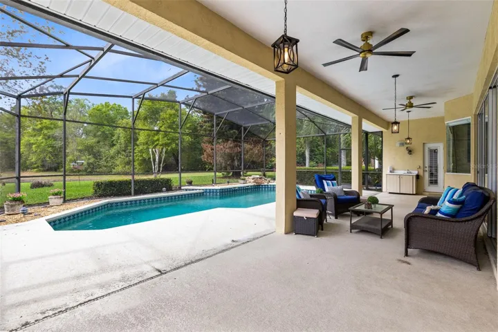 LOTS OF COVERED LANAI SPACE OUTSIDE TO ENTERTAIN BY THE POOL