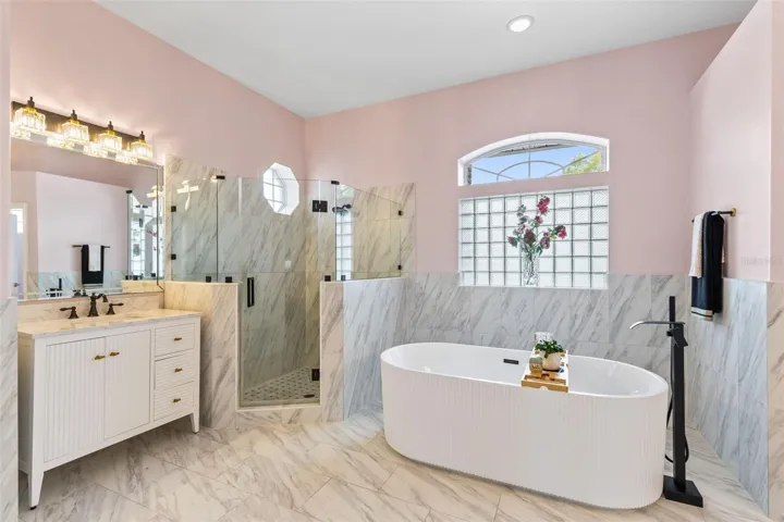 ALL NEW LIGHTING, TILE, FAUCETS AND PAINT IN THIS HUGE BATHROOM.
